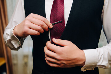 wedding, the groom gets dressed, fastens a button on his sleeve