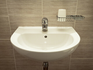 White sink on the wall in bathroom
