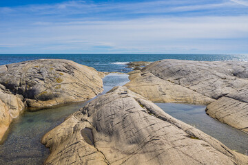 Rocky bay of Saint Lawrence Estuary in Riviere-au-Tonnerre, a small village located in Cote Nord region of Quebec, Canada