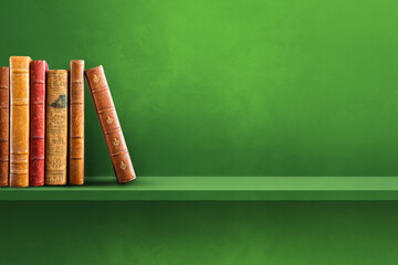 Row of old books on green shelf. Horizontal background