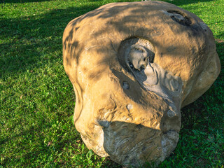 Obraz premium A stone with traces of melting as a result of high temperature. Molten volcanic rock.