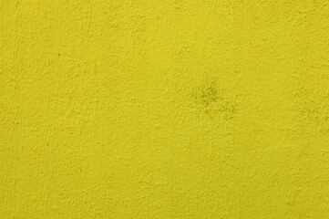 Abstract background of old worn yellow plaster on wall.
