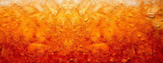 Close up view of the ice cubes in dark cola background. Texture of cooling sweet summer's drink with foam and macro bubbles on the glass wall. Fizzing or floating up to top of surface