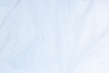 Obraz premium White cloth background abstract with soft waves,Closeup elegant crumpled of white silk fabric cloth background and texture. Luxury background design.