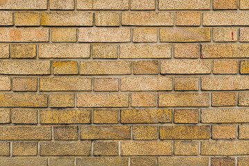 Pattern of a yellow brick wall structure as background