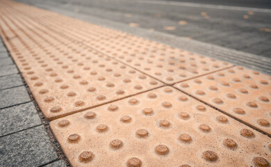 Fototapeta premium Yellow Braille blocks on public transport station for person with a physical disability