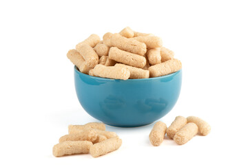 Sweet buckwheat sticks in a blue bowl and a few on a white background.