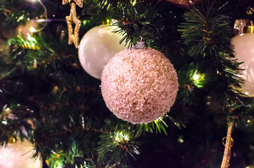 light pink christmas decoration balls on christmas tree