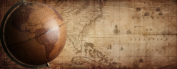 Ancient globe on the old map background. Selective focus. Retro style. Science, education, travel, vintage background. History and geography team. Blue tinted.