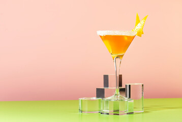 Sidecar classic alcoholic cocktail with cognac, liqueur, lemon juice and ice. Pink and green pop background, copy space