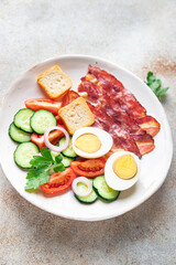 English breakfast eggs, bacon, tomato, cucumber, toast bread healthy meal diet snack on the table copy space food background rustic 