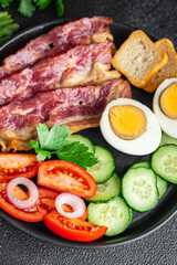 English breakfast eggs, bacon, tomato, cucumber, toast bread healthy meal diet snack on the table copy space food background rustic 