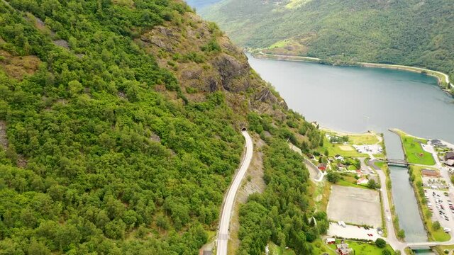 Road entering a mountain tunnel with scenic route