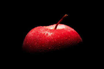 red apple with water drops on a black background