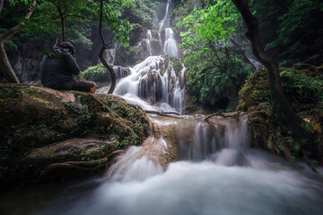 Erawan waterfall is the beautiful wild watefall in the deep rain forest of the national park in...