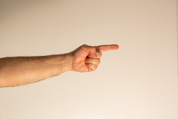 A hand gesture indicating the direction and pointing to a specific person, object, or something....