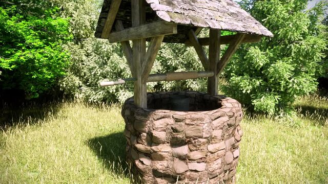 A close-up view of an old stone wishing well in the middle of a lush green forest.