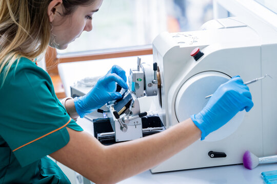 Laboratory assistant works on a rotary microtome section and making microscope slides