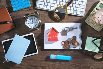 Coins, house model and keys with a business objects.