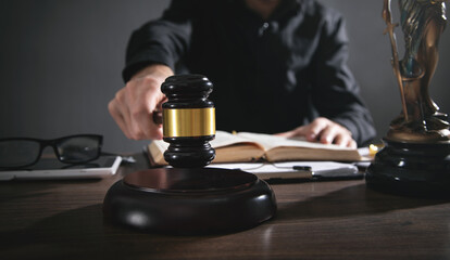 Male judge in a courtroom striking the gavel.