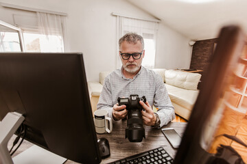 Photographer with beard, while working in his office at home.