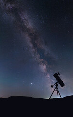 Newtonian reflector telescope silhouette on the background of the Milky Way 