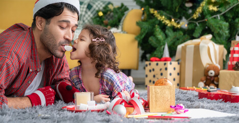 Happy Merry Christmas holiday and new year eve of father and cute daughter with decorating the Christmas tree and gift box in living room at home.