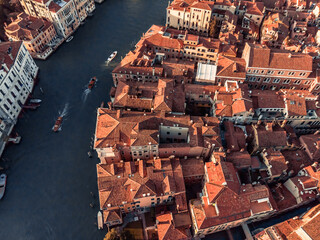 Aerial view of the vibrant Grand Canal at sunset near Venice. Movement of boats and handles along the canal near
embankment. The historic center of Venice from a drone. Pleasure boats in Italy