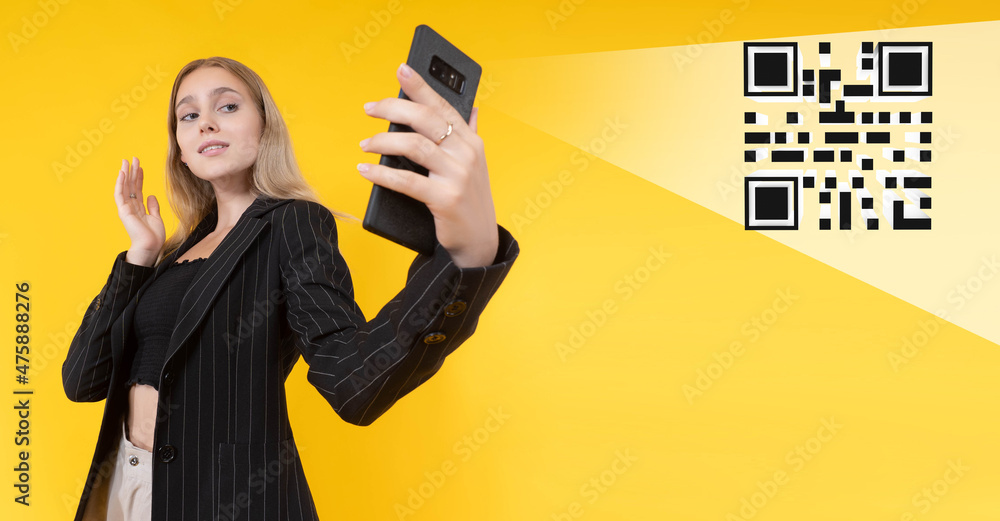 Poster scanning qr codes. use of qr technology. matrix code on yellow background. girl with phone is identi