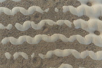 Concrete channel lining surface voids filled with dirt and sand