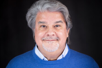 Adult man Studio headshot. He is smiling and wearing casual clothing