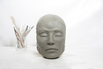 Head sculpture isolated and tools art craft on white background. Female mask portrait.