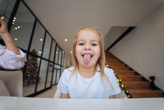 Little girl sticking out tongue at camera close-up