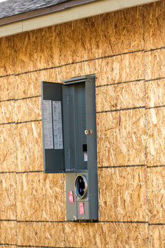 Electrical Utilities And  Breaker Box Installed In A New Plywood Wall Portrait Orientation