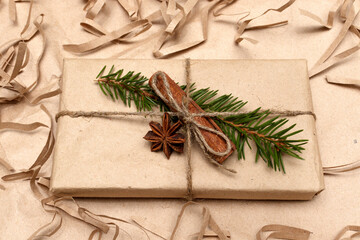 Gift box in craft paper and natural decorations, creative and zero waste holidays present wrapping, alternative zero waste concept.