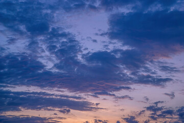Obraz premium Beautiful view of sky with clouds at sunrise. Partly cloudy. Colorful sunset. Natural blue sky background texture, beautiful color.