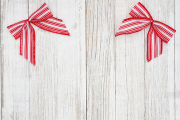 Red and white candy cane bow Christmas background with weathered wood