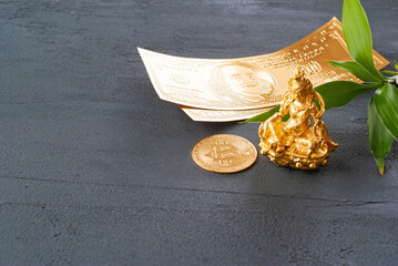 Golden Ganesha with gold dollars and bitcoin gold coin