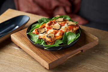 close up shot of a delicious gourmet slice of lasagna bolognese on a wooden board