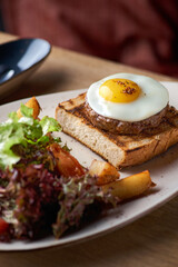scrambled eggs with steak - classic English breakfast with egg and potato wedges