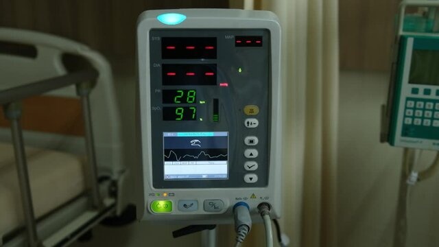 Low light handheld footage with noise effect added of vital sign monitor used in a hospital.
