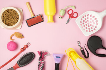 Accessories for animals on a pink background. Leash, water bottle, toys, hairbrush, food in a bowl....