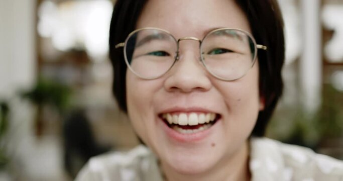 Close up portrait of Asian woman smiling and happy laughing in the garden. good dental health. positive attitude. Wellbeing in today society. mental health care. live with covid with safety