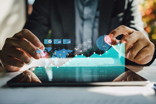 Business analyzing big data screen and economic growth with financial diagram graph interfaces. Concept of virtual dashboard technology digital marketing and global network connection from tablet.