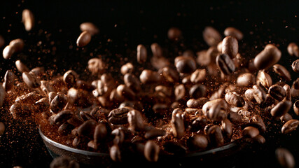 Fototapeta Freeze motion of flying roasted coffee beans on black. obraz
