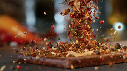 Freeze motion of falling spice mix on cutting board.