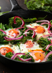 Green shakshuka with golden yolk eggs, kale, spinach and tender broccoli served with pickled onions and chilli flakes