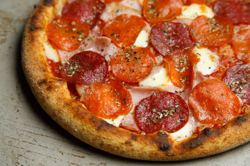 pizza with salami and tomatoes