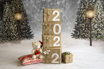  Christmas boxes with gifts and 2022 on a winter background with Christmas trees and lanterns       
