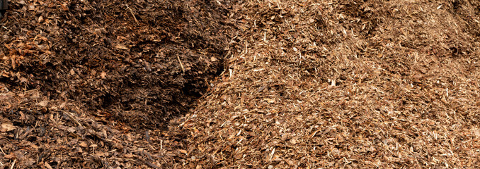 Background of chipped mulch pieces. Used as fertilizer and rataining water for garden plants.